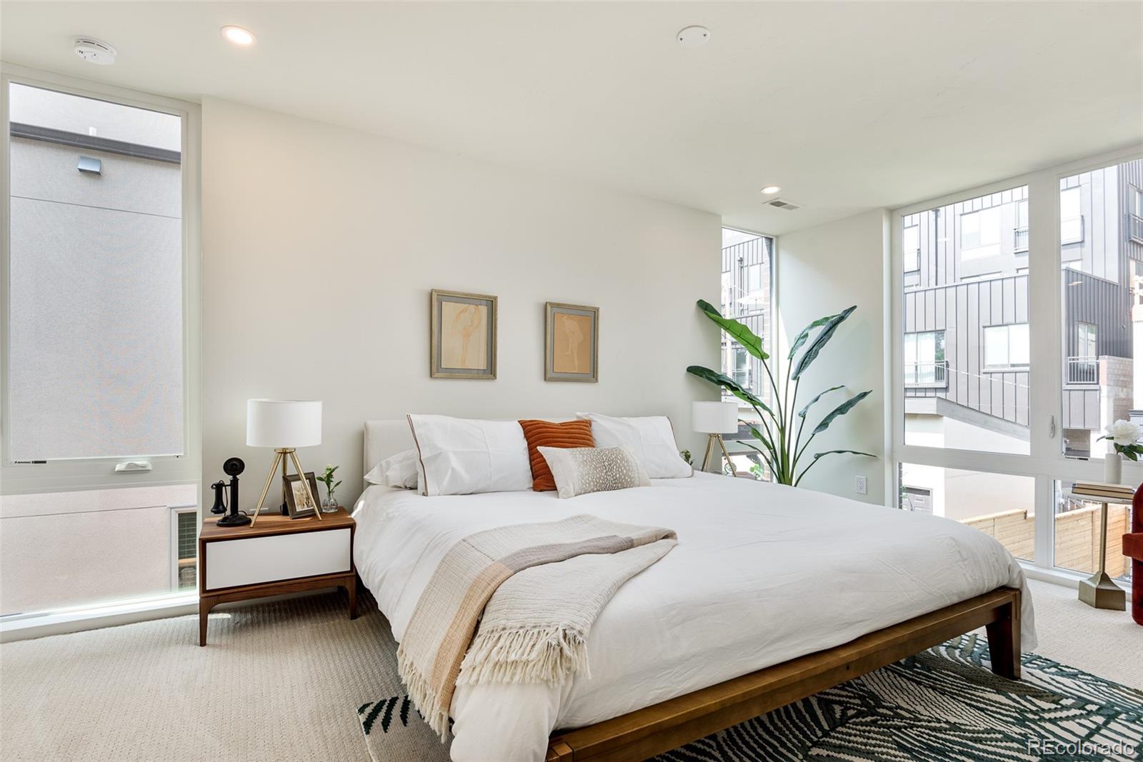 3865 Stuart Street Denver, CO 80212 - Photo 17 of 32 a bedroom with a large bed and a potted plant