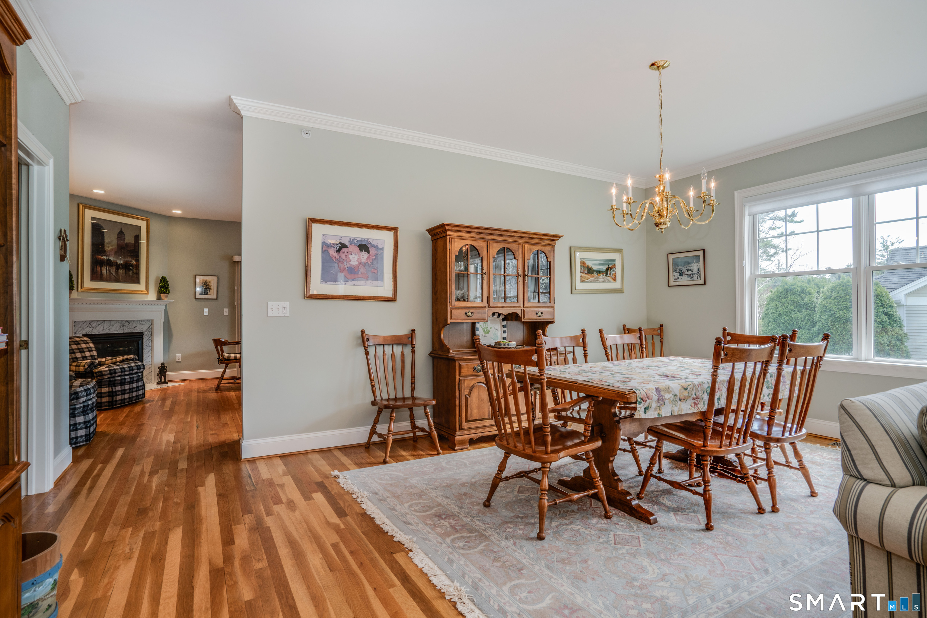 6 Bittersweet Lane, Unit 6 Avon, CT 06001 - Photo 12 of 39 a view of a dining room with furniture a chandelier and wooden floor