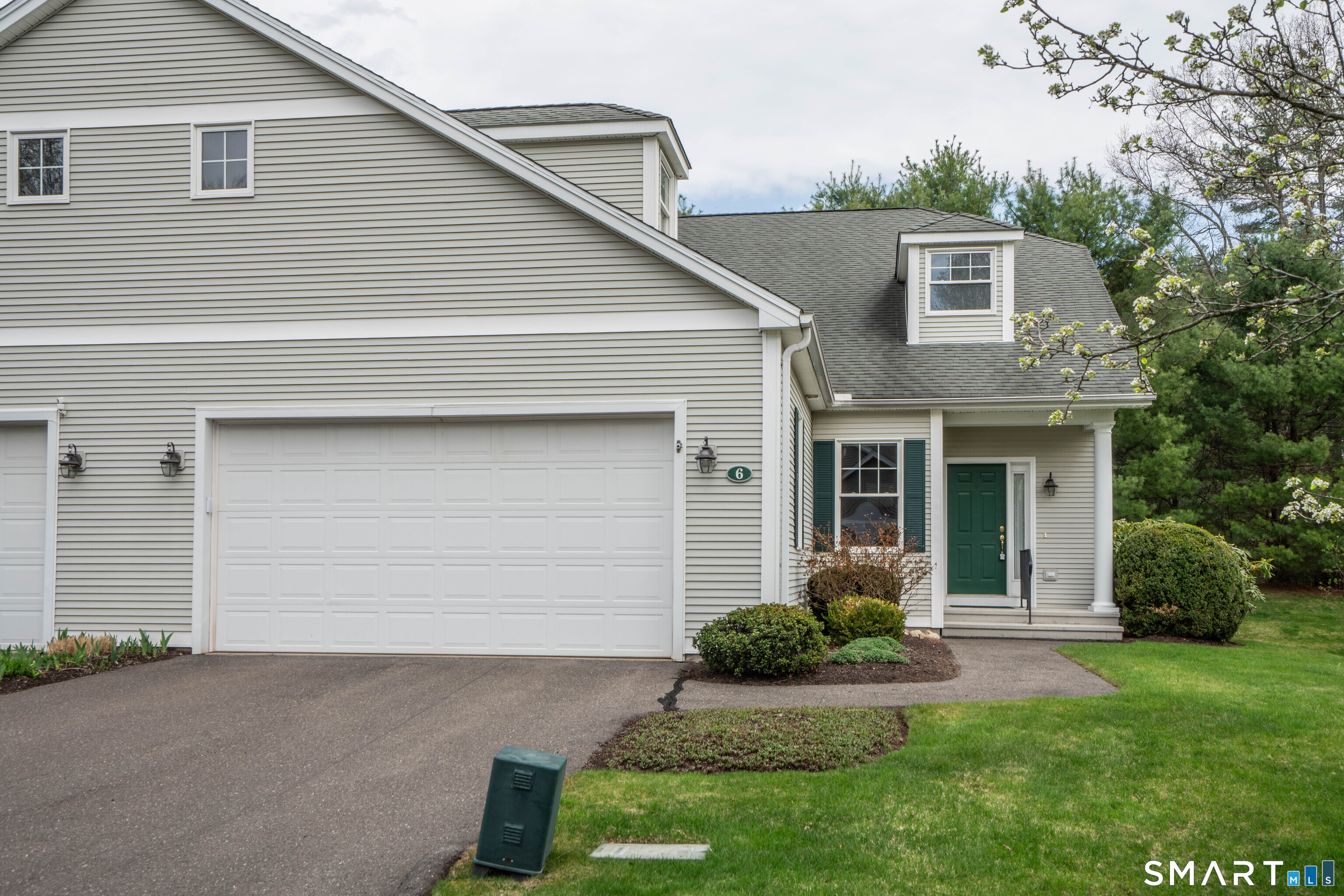 6 Bittersweet Lane, Unit 6 Avon, CT 06001 - Photo 2 of 39 a front view of a house with a yard and garage