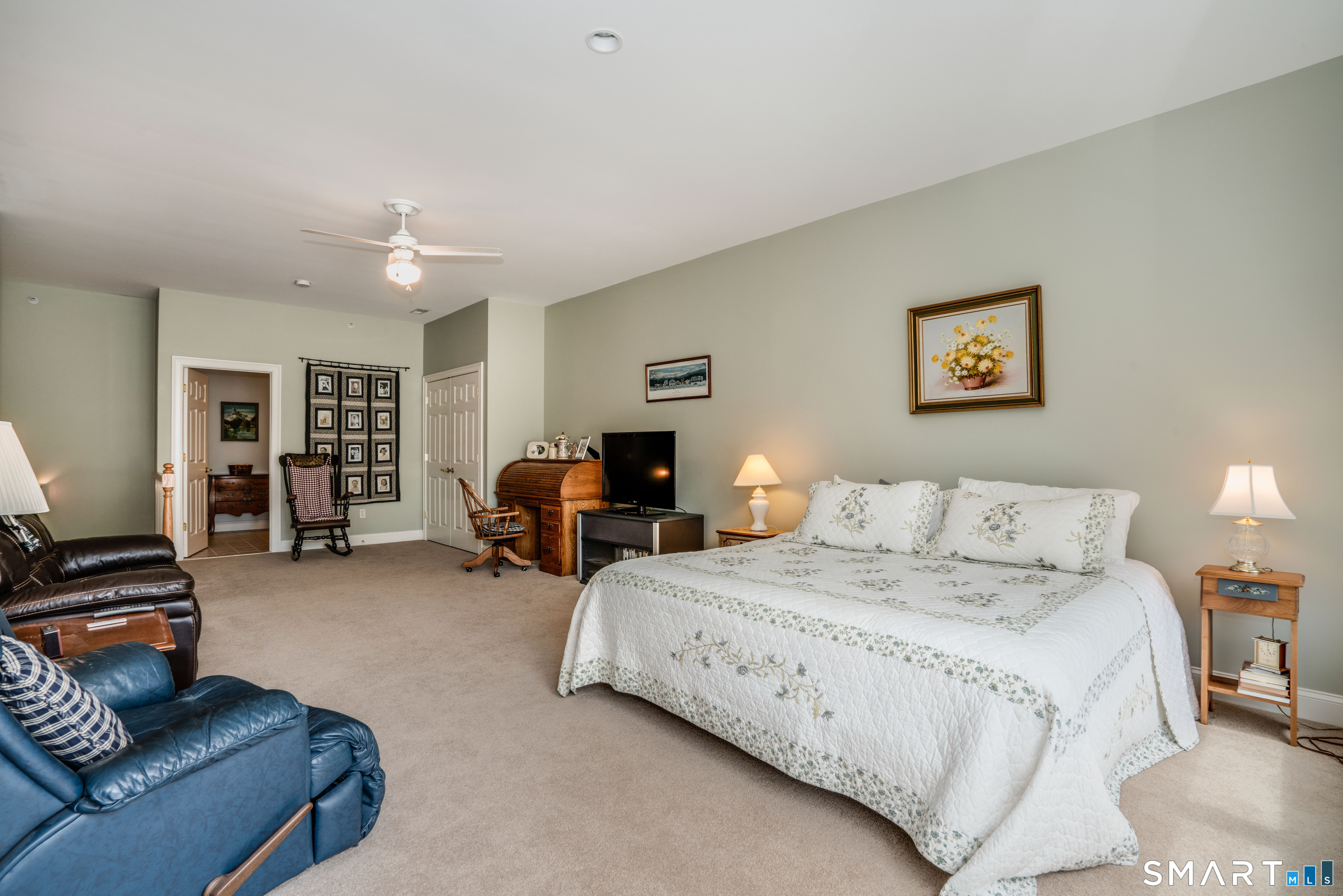 6 Bittersweet Lane, Unit 6 Avon, CT 06001 - Photo 32 of 39 a spacious bedroom with a bed couch and a desk
