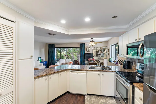 a kitchen with sink cabinets and window