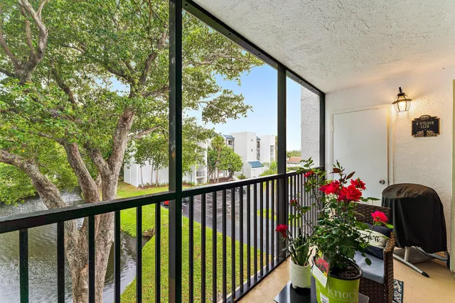 a bedroom with bed and a flat tv screen on dresser