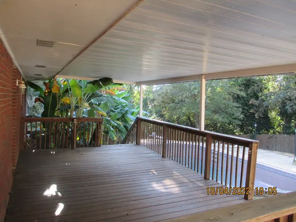 a view of a patio with wooden floor