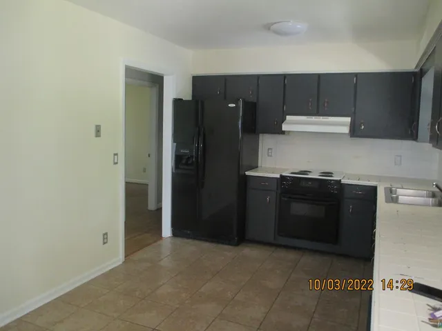 a kitchen with a stove and a refrigerator