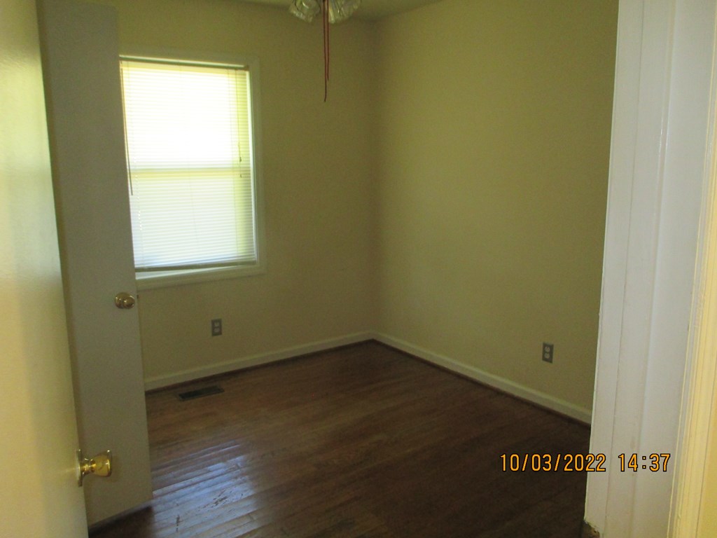 3136 Leafmore Court Columbus, GA 31909 - Photo 7 of 9 an empty room with wooden floor and windows