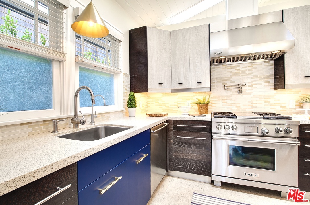 754 Palms Boulevard Venice, CA 90291 - Photo 11 of 45 a kitchen with granite countertop a stove sink and cabinets