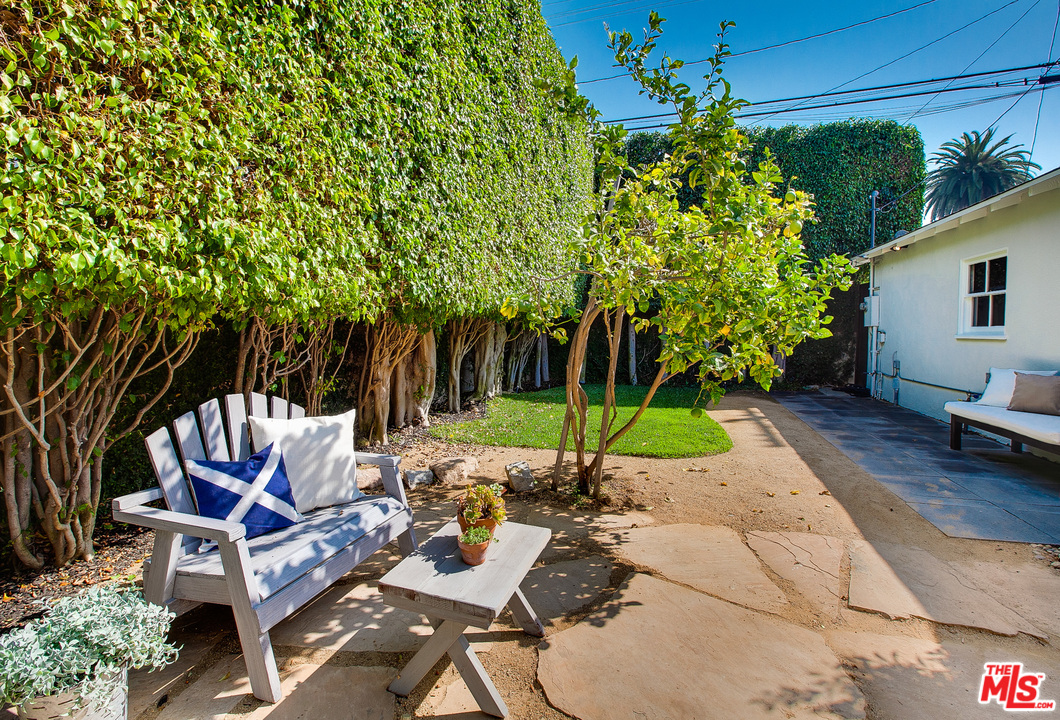 754 Palms Boulevard Venice, CA 90291 - Photo 19 of 45 a view of a patio with a table and chairs under an umbrella