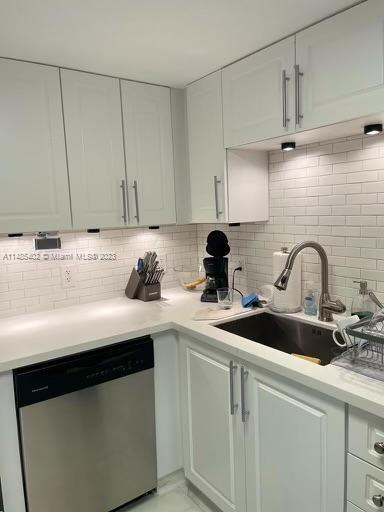 280 Southwest 20th Road, Unit 903 Miami, FL 33129 - Photo 11 of 26 a kitchen with stainless steel appliances a sink a stove and cabinets