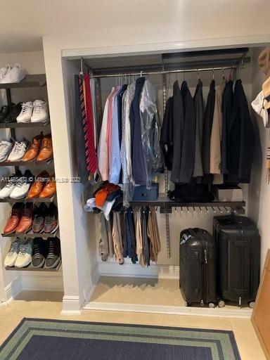 280 Southwest 20th Road, Unit 903 Miami, FL 33129 - Photo 18 of 26 a view of walk in closet with clothes and shoes