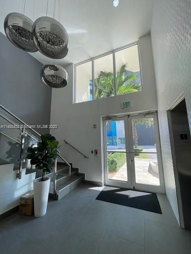 280 Southwest 20th Road, Unit 903 Miami, FL 33129 - Photo 3 of 26 a dining room with a window and chandelier