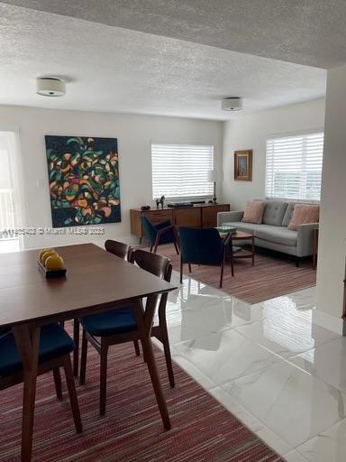 280 Southwest 20th Road, Unit 903 Miami, FL 33129 - Photo 4 of 26 a living room with furniture a table and a large window