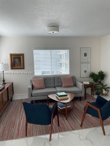 280 Southwest 20th Road, Unit 903 Miami, FL 33129 - Photo 6 of 26 a living room with furniture and a large window