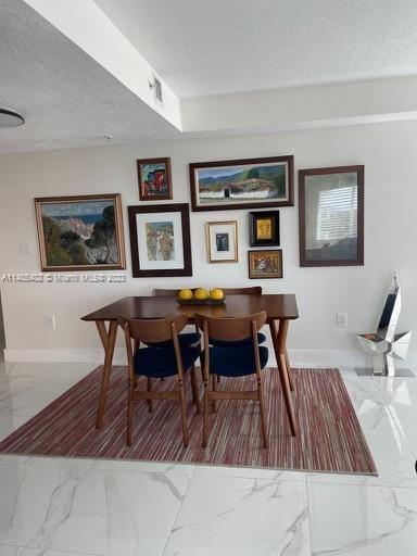 280 Southwest 20th Road, Unit 903 Miami, FL 33129 - Photo 7 of 26 a view of a dining room with furniture and wooden floor