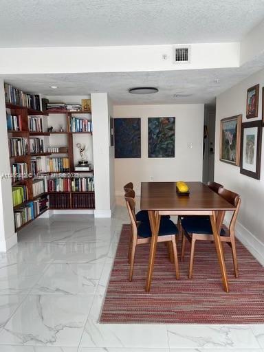 280 Southwest 20th Road, Unit 903 Miami, FL 33129 - Photo 8 of 26 a view of a dining room with furniture and wooden floor