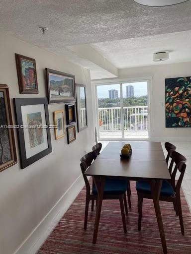 280 Southwest 20th Road, Unit 903 Miami, FL 33129 - Photo 9 of 26 a view of a dining room with furniture and wooden floor