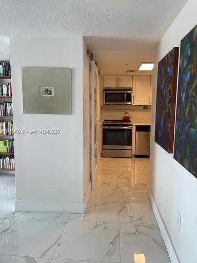 280 Southwest 20th Road, Unit 903 Miami, FL 33129 - Photo 10 of 26 a large kitchen with cabinets and stainless steel appliances