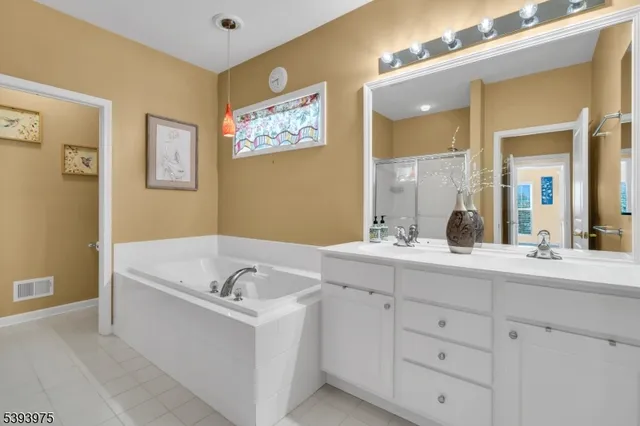 a bathroom with a bathtub sink and mirror