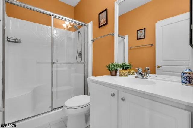 a bathroom with a sink a mirror a toilet and shower