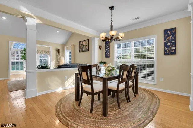 a view of a dining room with furniture wooden floor and chandelier