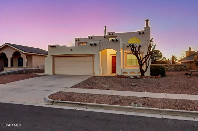 a front view of a house with parking area