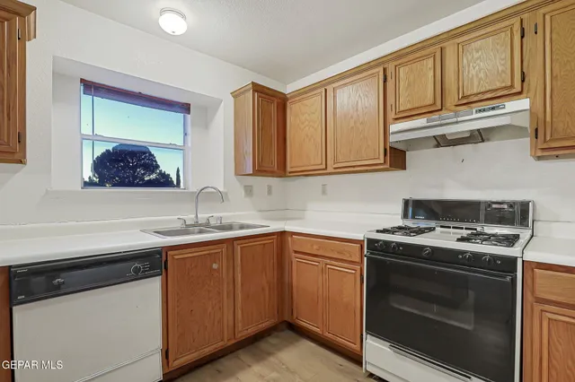 a kitchen with stainless steel appliances granite countertop a sink stove and cabinets