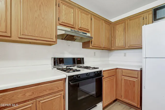 a kitchen with stainless steel appliances a refrigerator sink and cabinets