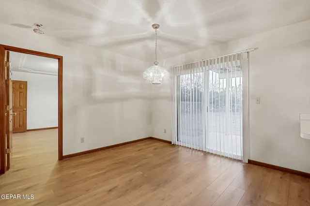 a large kitchen with stainless steel appliances granite countertop a sink a counter space and wooden floor