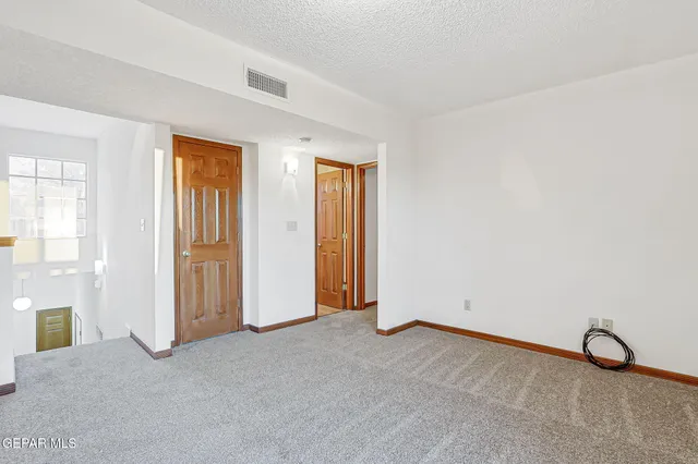 an empty room with closet and a window
