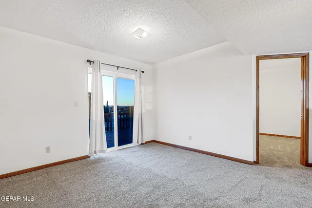 an empty room with closet and mirror