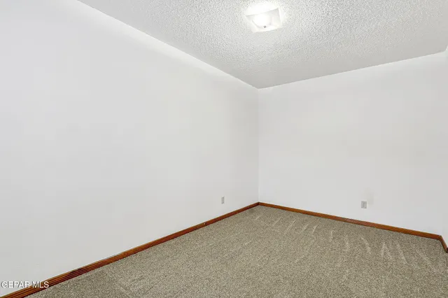 a view of a house with backyard and a parking space