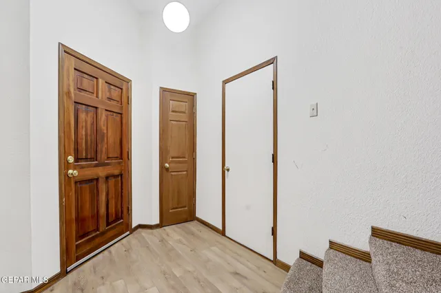 a view of an entryway with wooden floor