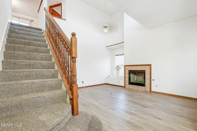 a view of an entryway with wooden floor and a fireplace