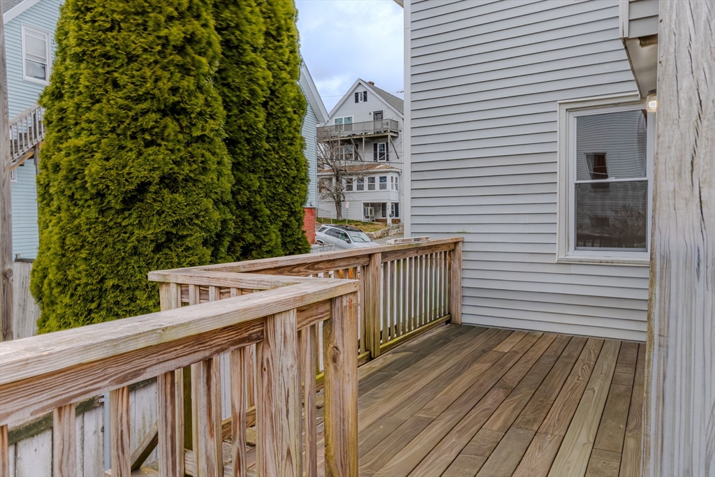 34 Perkins Street, Unit 2 Gloucester, MA 01930 - Photo 16 of 19 a view of a balcony with wooden floor and fence