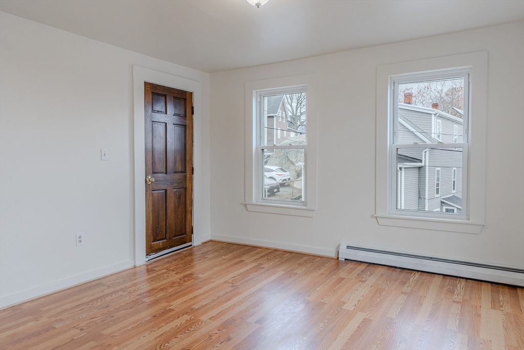 34 Perkins Street, Unit 2 Gloucester, MA 01930 - Photo 3 of 19 a view of empty room with wooden floor and fan