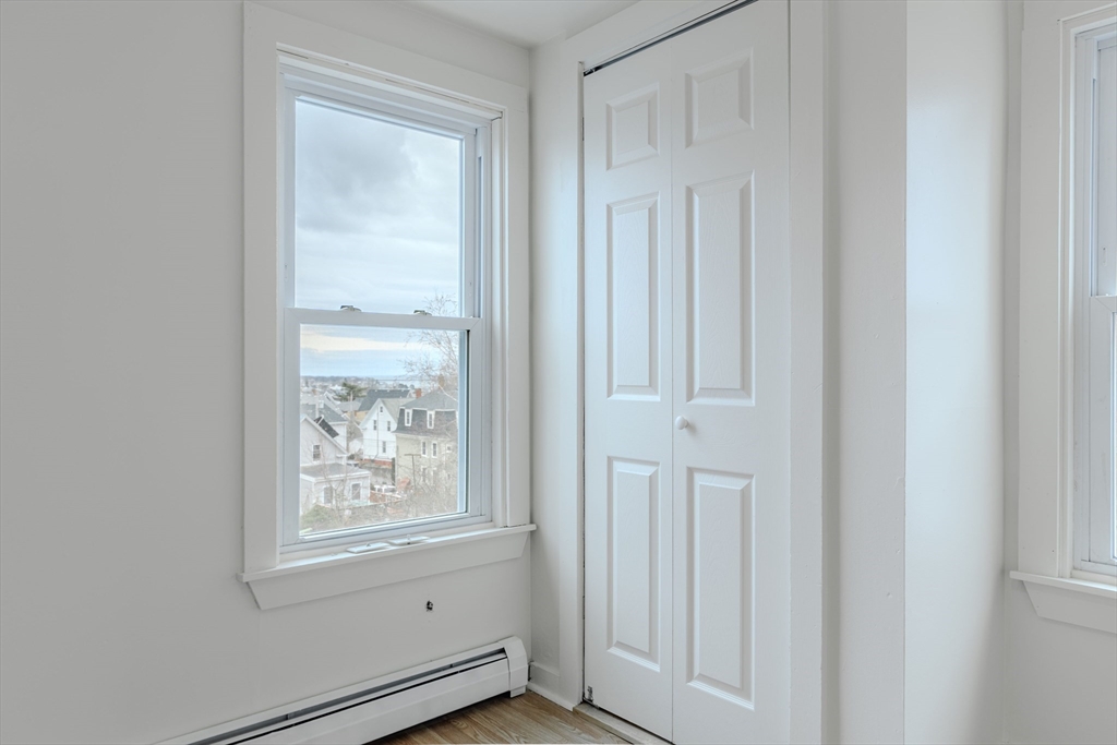 34 Perkins Street, Unit 2 Gloucester, MA 01930 - Photo 10 of 19 a view of an empty room with wooden floor and a window