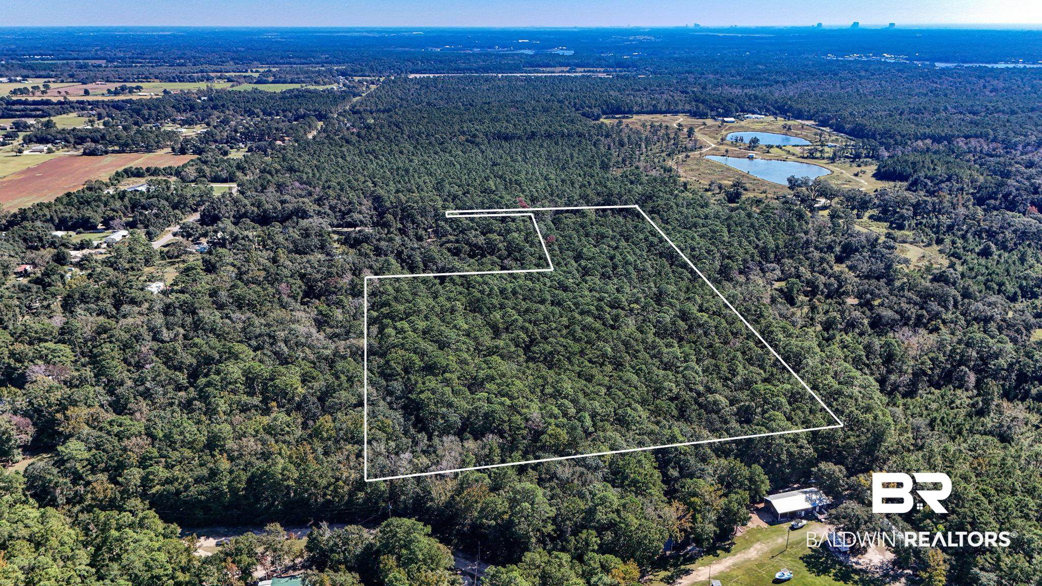 0 Bemis Lane Bon Secour, AL 36511 - Photo 1 of 8 Aerial view of property's location featuring a large body of water and property parcel outlined