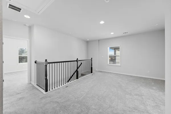 a view of an empty room and a window