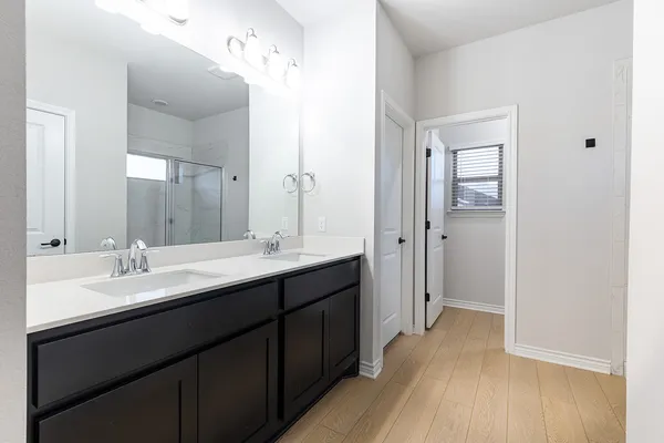 a bathroom with a glass shower door