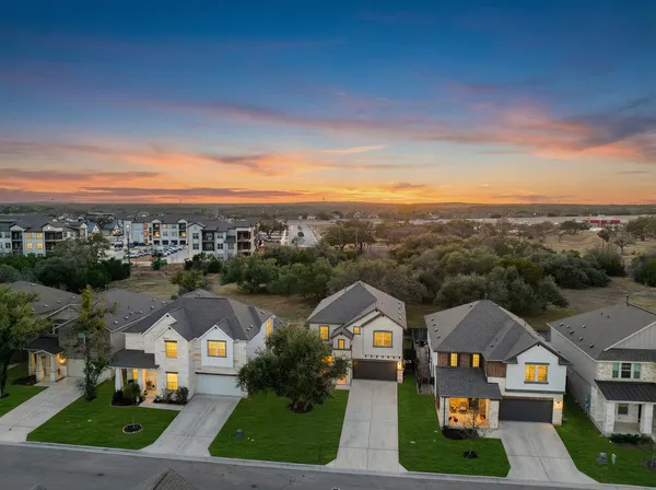 an aerial view of residential houses with outdoor space and street view