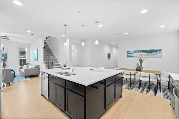 a large kitchen with a table and chairs