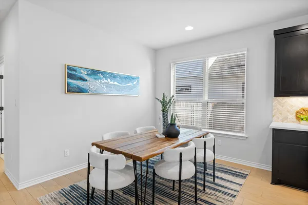 a view of a dining room with furniture window and wooden floor