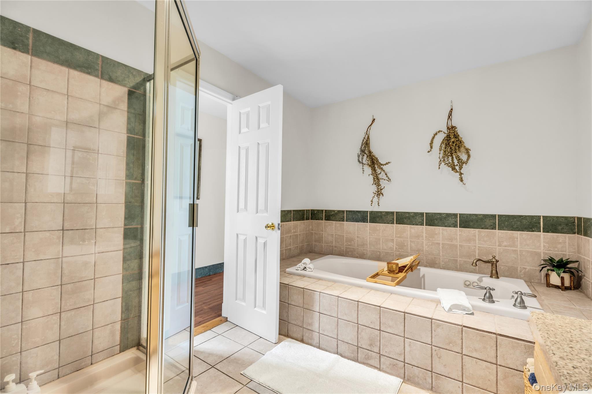 64 Sally Lane Ridge, NY 11961 - Photo 12 of 18 Full bath with light tile patterned flooring, a shower stall, and a garden tub