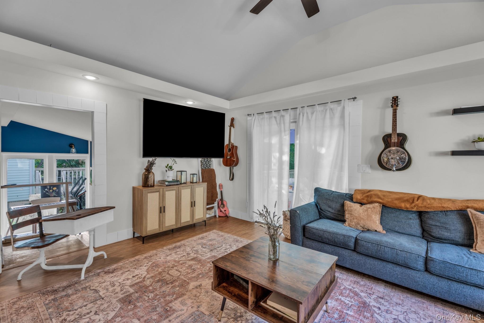 64 Sally Lane Ridge, NY 11961 - Photo 5 of 18 Living area featuring vaulted ceiling, plenty of natural light, wood finished floors, a ceiling fan, and recessed lighting