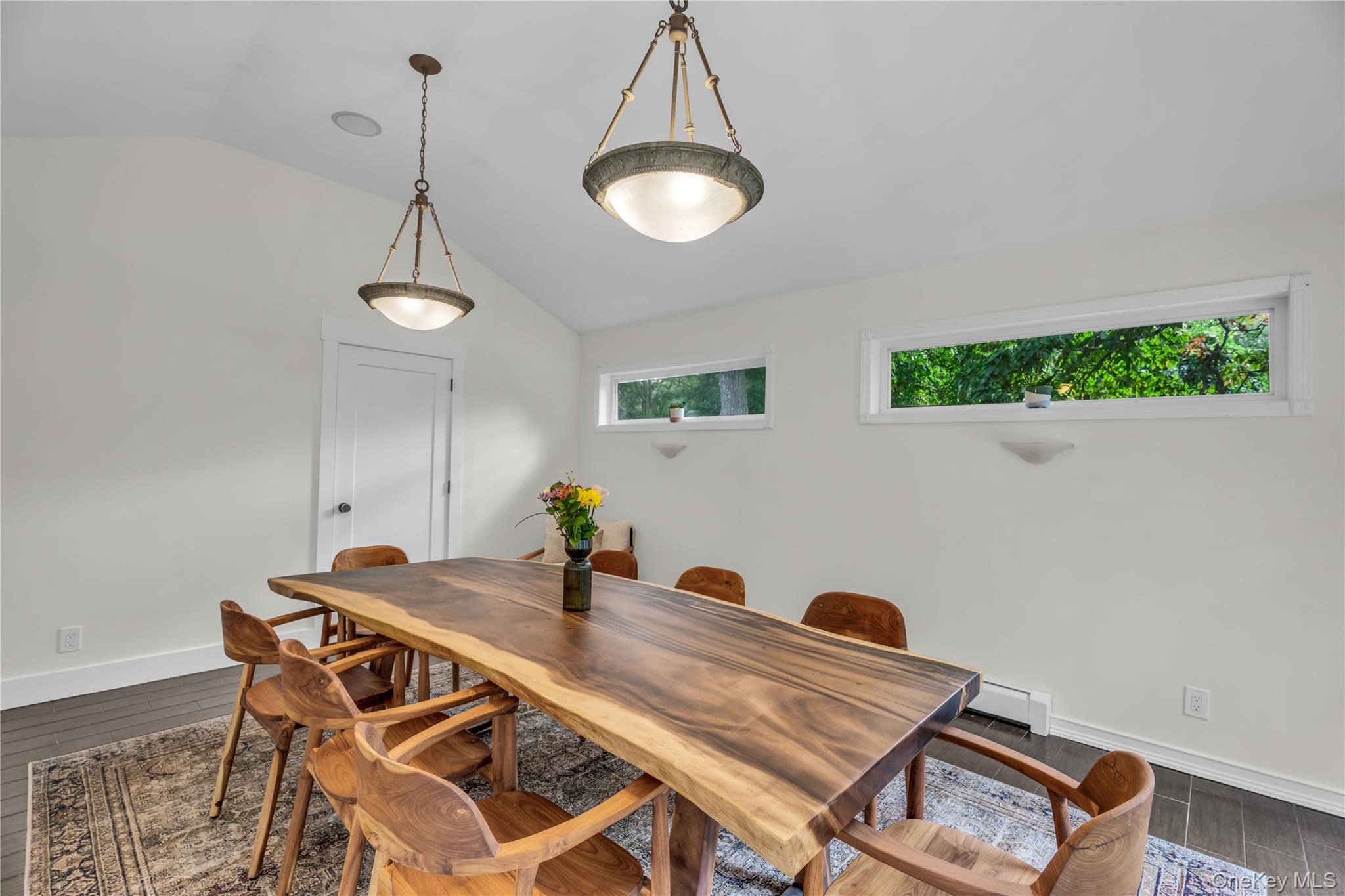 64 Sally Lane Ridge, NY 11961 - Photo 9 of 18 Dining room with wood finish floors, vaulted ceiling, and a baseboard heating unit