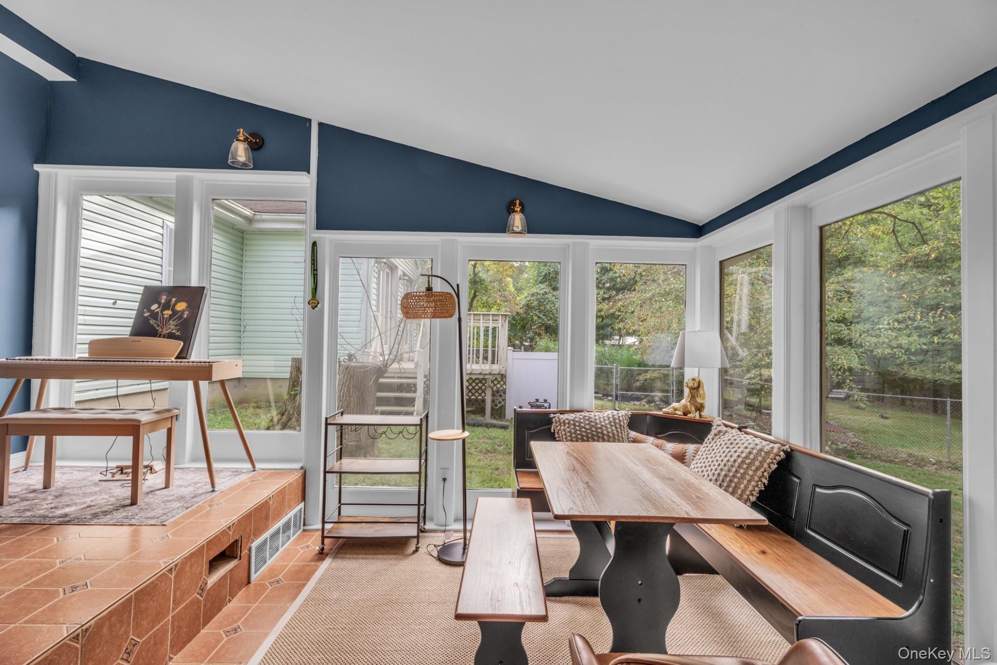 64 Sally Lane Ridge, NY 11961 - Photo 10 of 18 Sunroom / solarium with vaulted ceiling, plenty of natural light, and carpet flooring