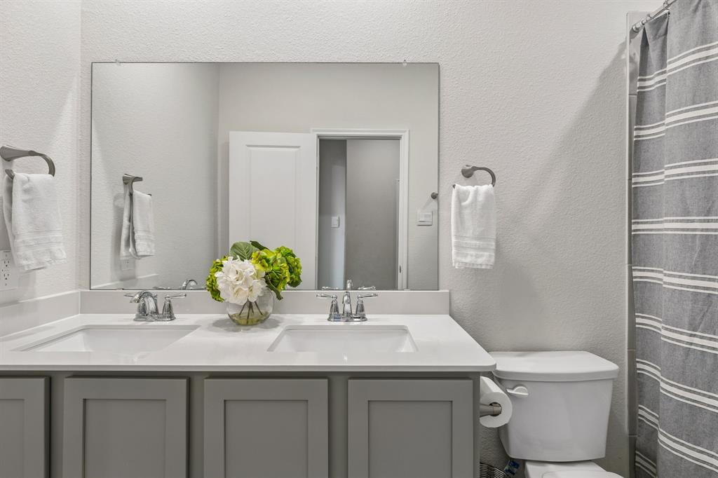 10313 Geode Street Aubrey, TX 76227 - Photo 10 of 13 Dual vanity with integrated white sinks and chrome fixtures