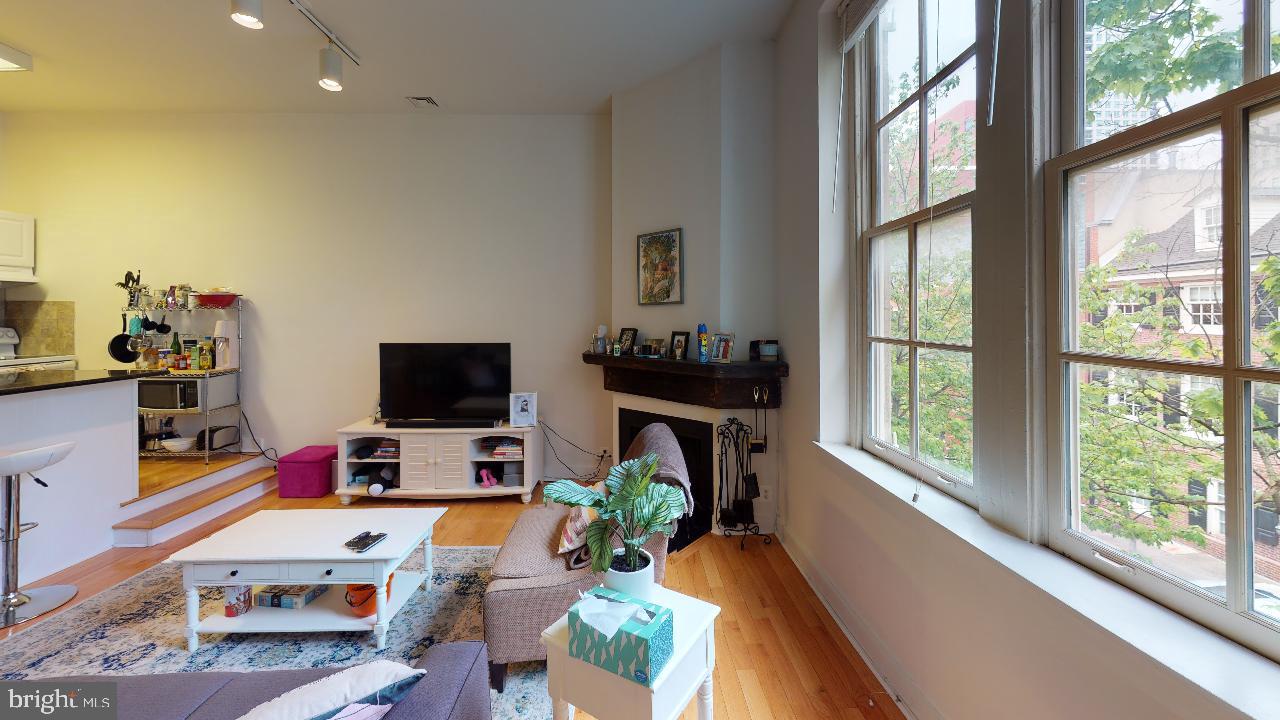 260 South 9th Street, Unit 2F Philadelphia, PA 19107 - Photo 3 of 8 a living room with furniture and a flat screen tv