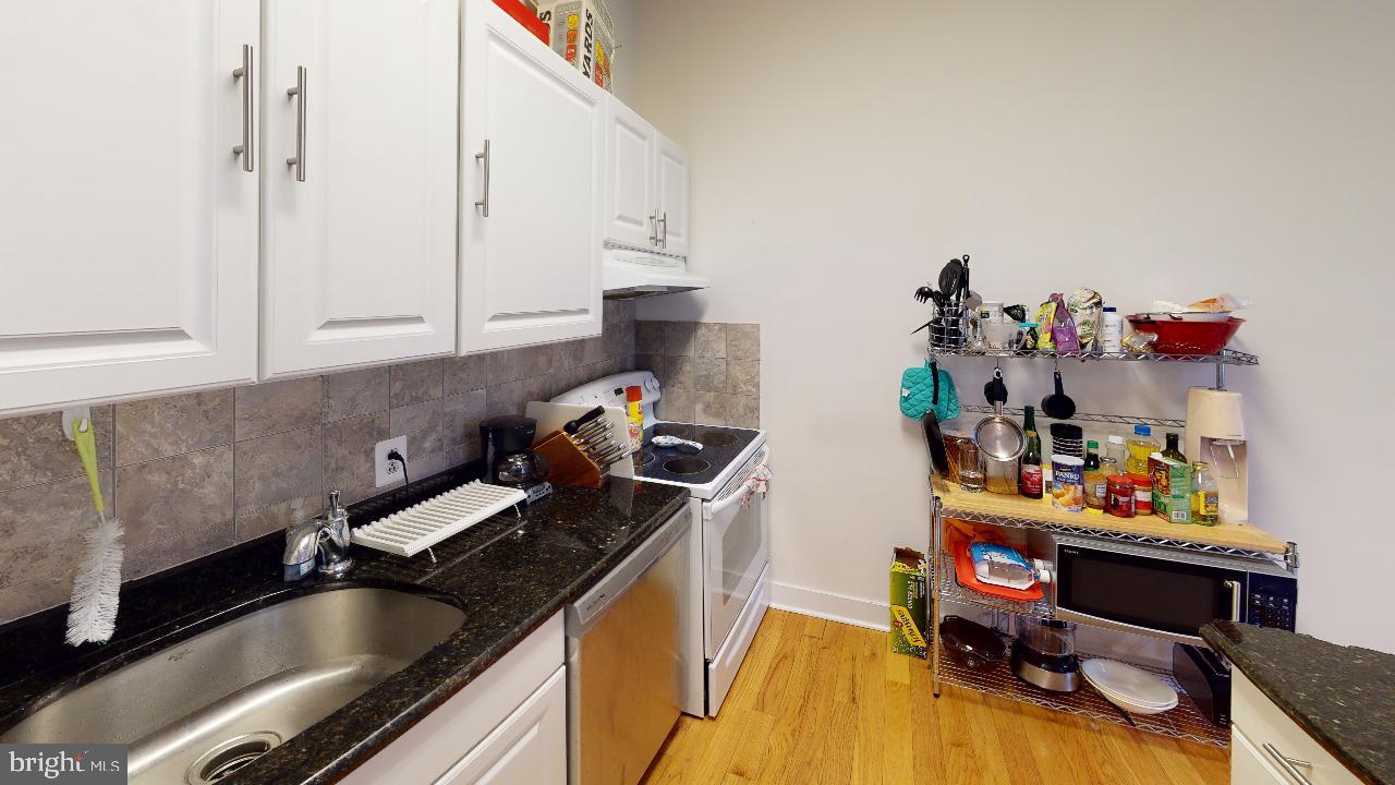 260 South 9th Street, Unit 2F Philadelphia, PA 19107 - Photo 4 of 8 a kitchen with a sink cabinets and appliances