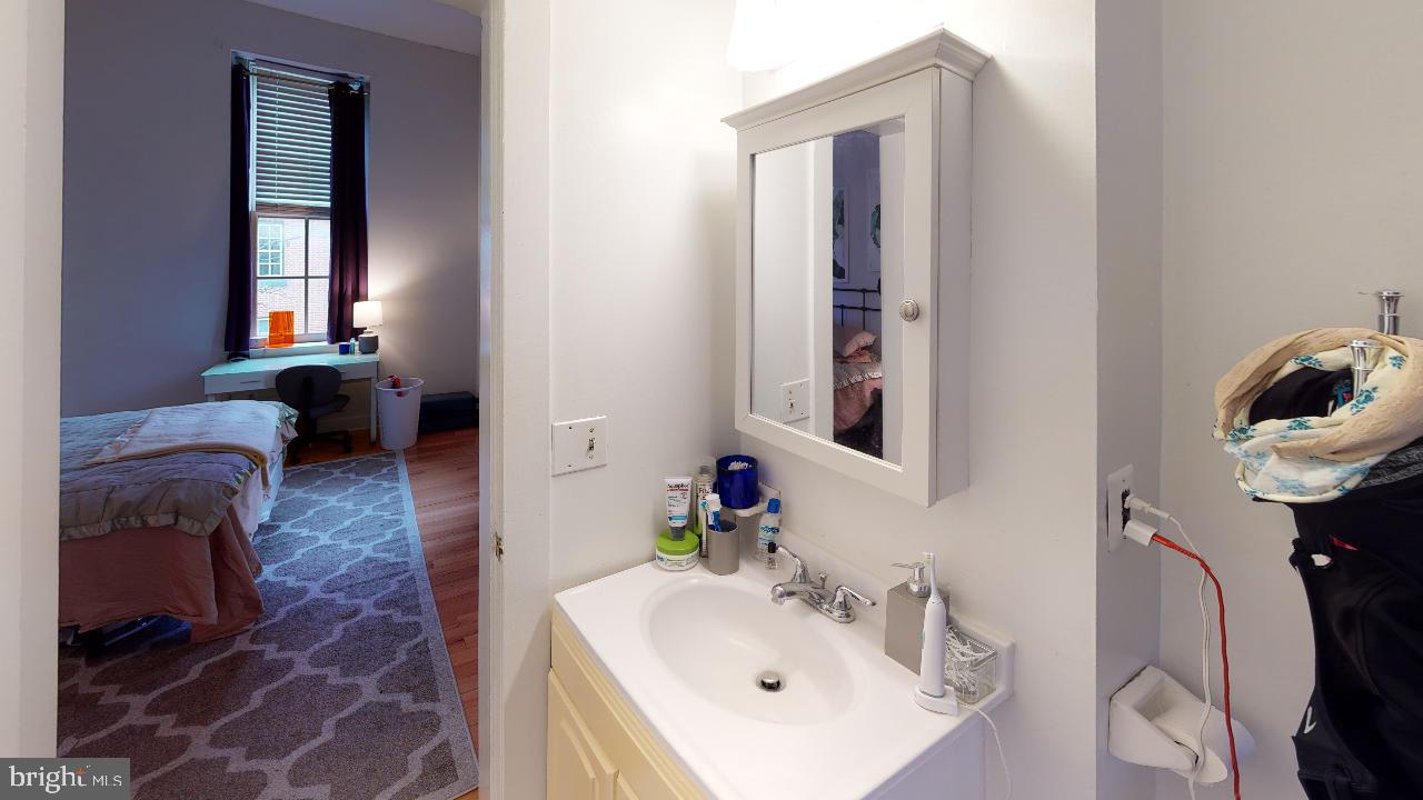 260 South 9th Street, Unit 2F Philadelphia, PA 19107 - Photo 5 of 8 a bathroom with a sink and a mirror
