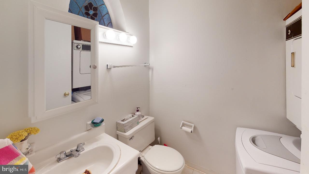 260 South 9th Street, Unit 2F Philadelphia, PA 19107 - Photo 6 of 8 a white toilet sitting next to a bathroom sink